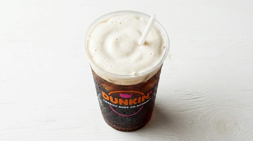 Dunkin Dirty Soda April 2026 made with Pepsi coffee milk and sweet cold foam in an orange Dunkin cup