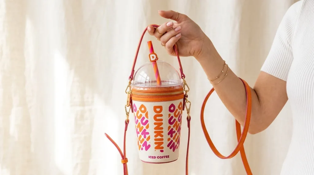 Dunkin' x Stoney Clover Lane 2026 Iced Coffee Crossbody Bag in orange with straw detail, limited-edition National Donut Day drop priced at $98
